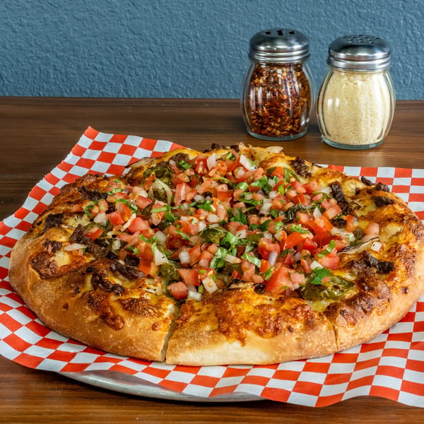 Pizza Presidente's pizza with diced tomatoes, onions, cilantro, and jalapeños, with parmesan and chili flakes.